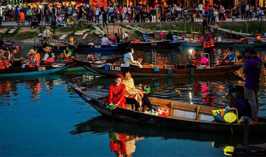 Rowboats hung with paper lanterns on the Hoai river at night in Hoi An